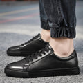 Men's Leather-Look Low-Top Trainers - Lace-Up Plain Toe - Black, worn on foot